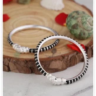 925 flexible baby bangle with black beads and silver rings with fish faces at the end